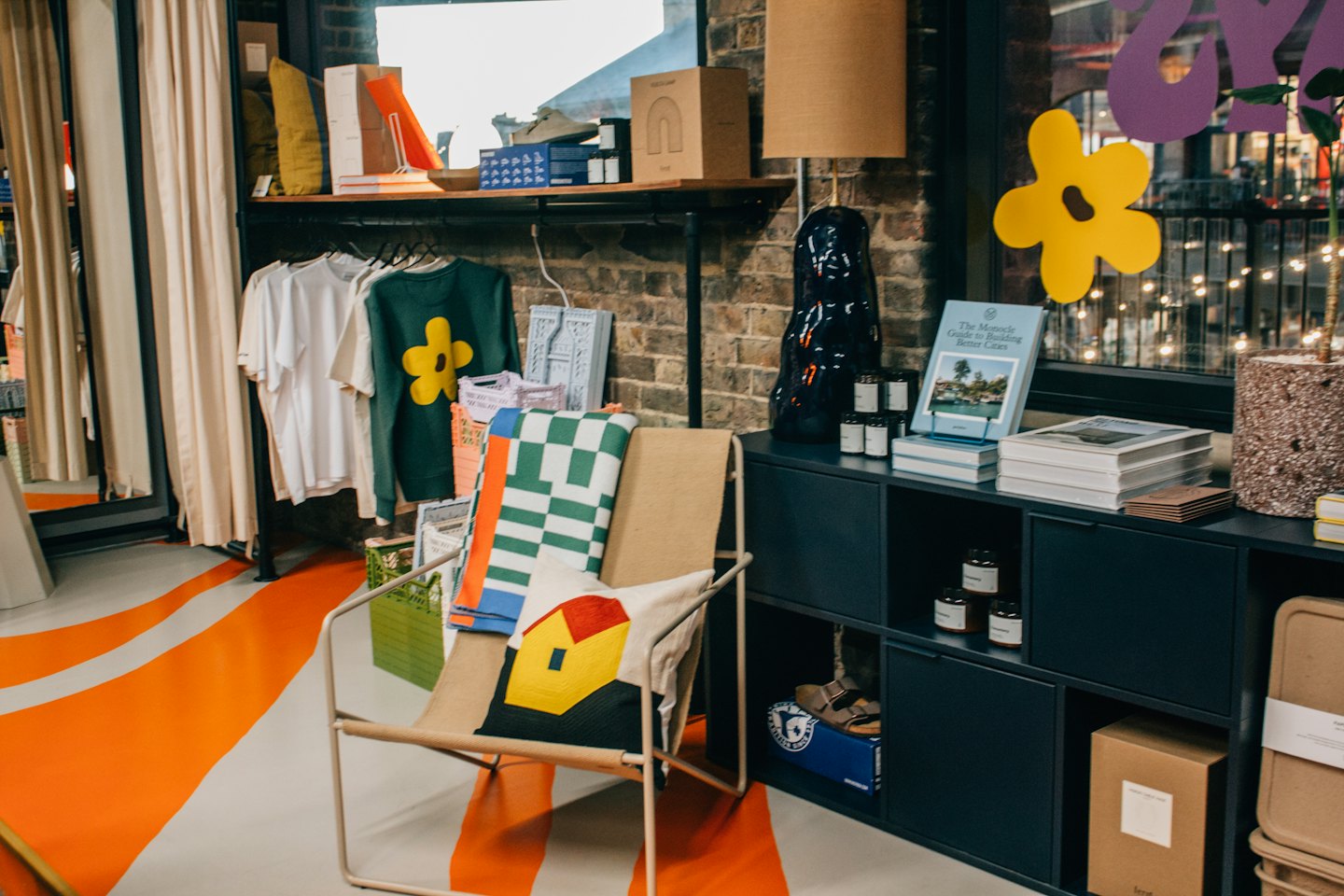 Modern home decor items and apparel displayed in a retail showroom.